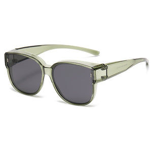 Oversized sunglasses in matcha green with dark lenses and side shields.