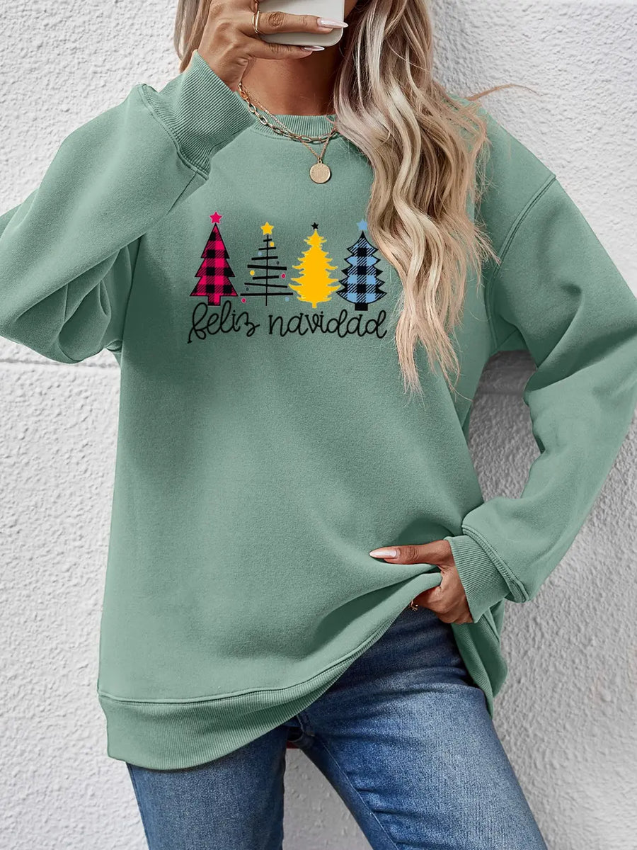 Sage green crewneck sweatshirt with Feliz Navidad graphic and plaid Christmas trees.