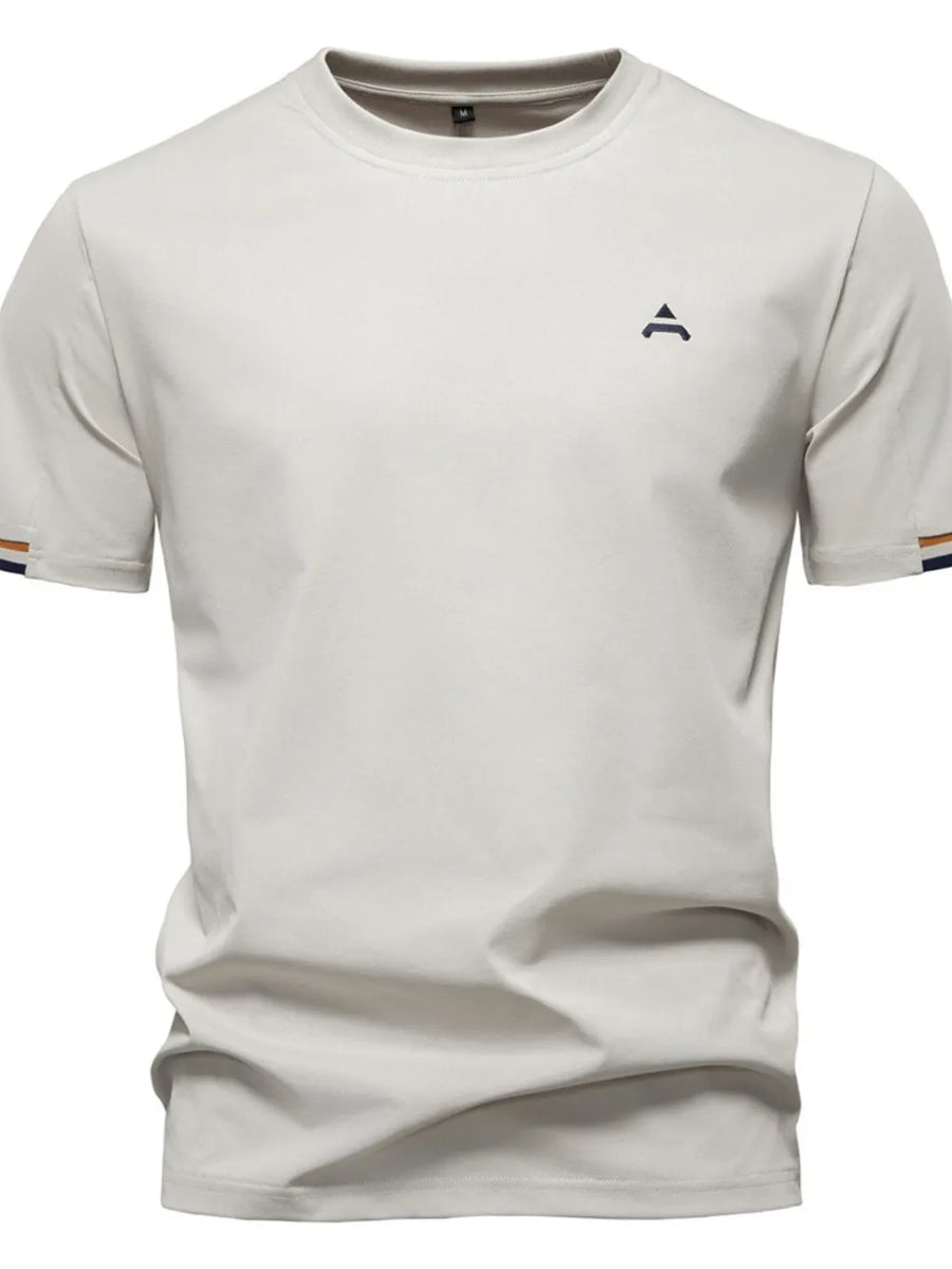 Beige t-shirt with embroidered crest detail and striped sleeve cuffs