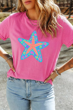 Pink t-shirt with a blue starfish graphic filled with colorful flowers