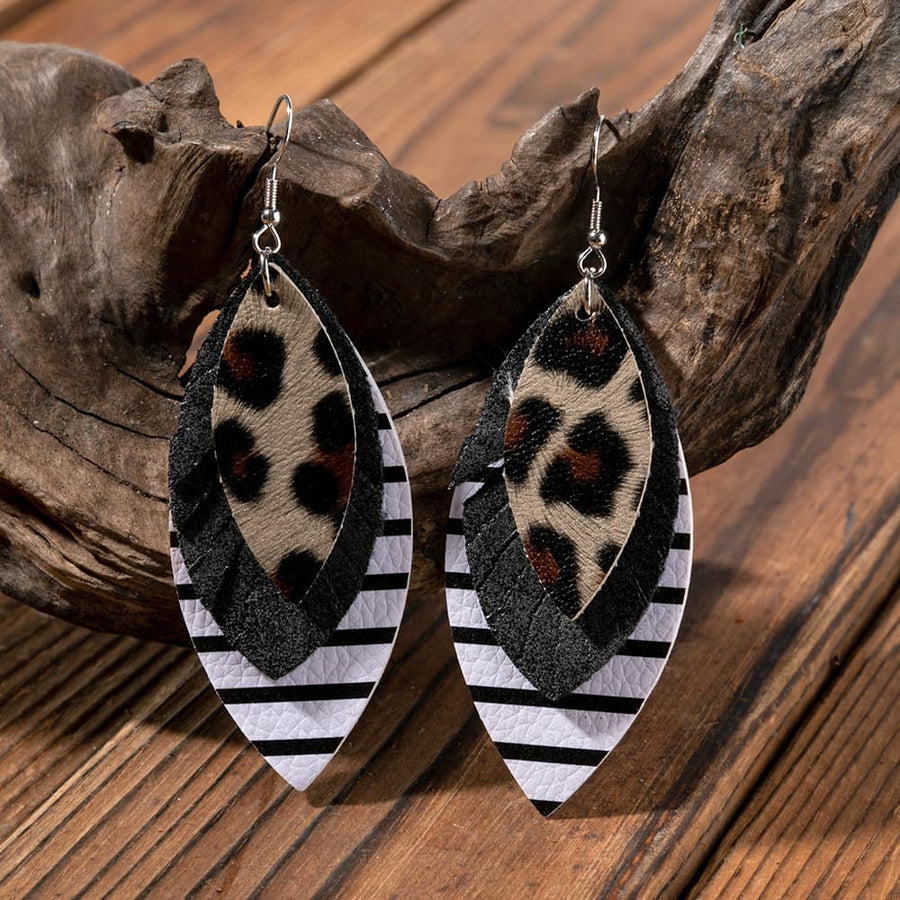 Layered faux leather statement earrings with leopard print, black, and stripe patterns.