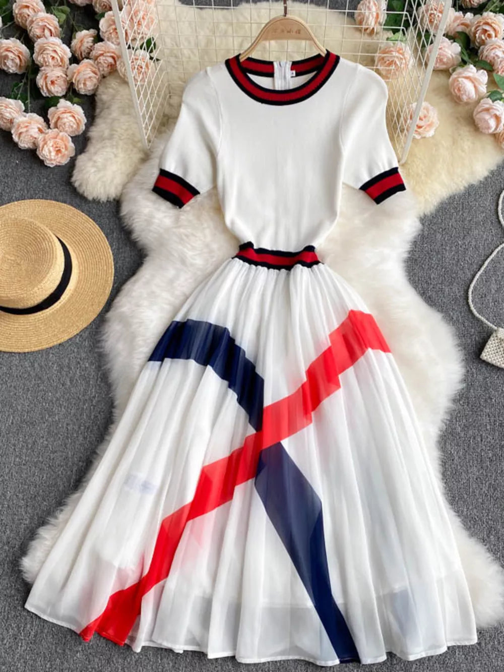 White midi dress with color block pleated skirt and striped trim