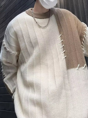Oversized white and khaki color block sweater with textured knit and visible stitching details.