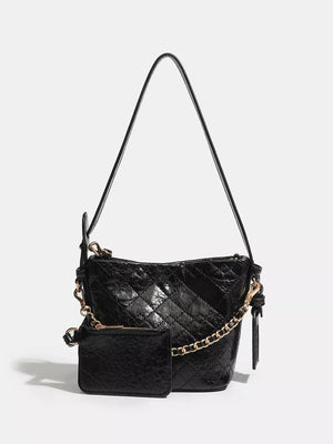 Black quilted bucket bag with chain accent and matching coin purse