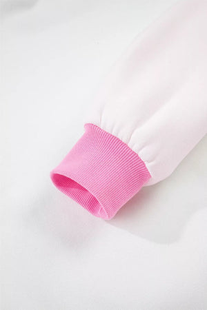 Cotton sweatshirt sleeve cuff detail in pink rib knit on a white sweatshirt.