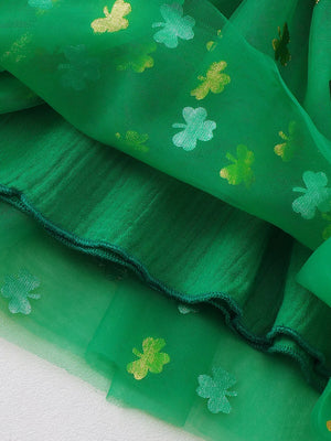 Green tulle baby dress with shamrock print and smocked detail.