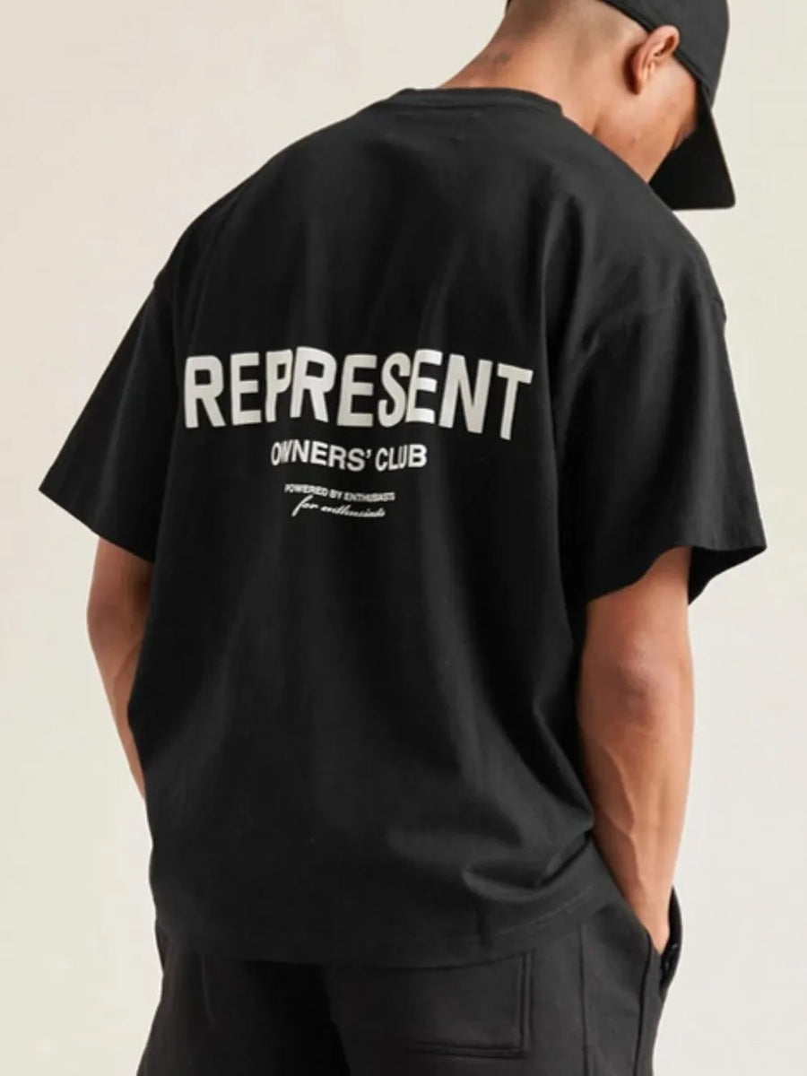 Black oversized graphic tee with white "REPRESENT OWNERS' CLUB" text on back
