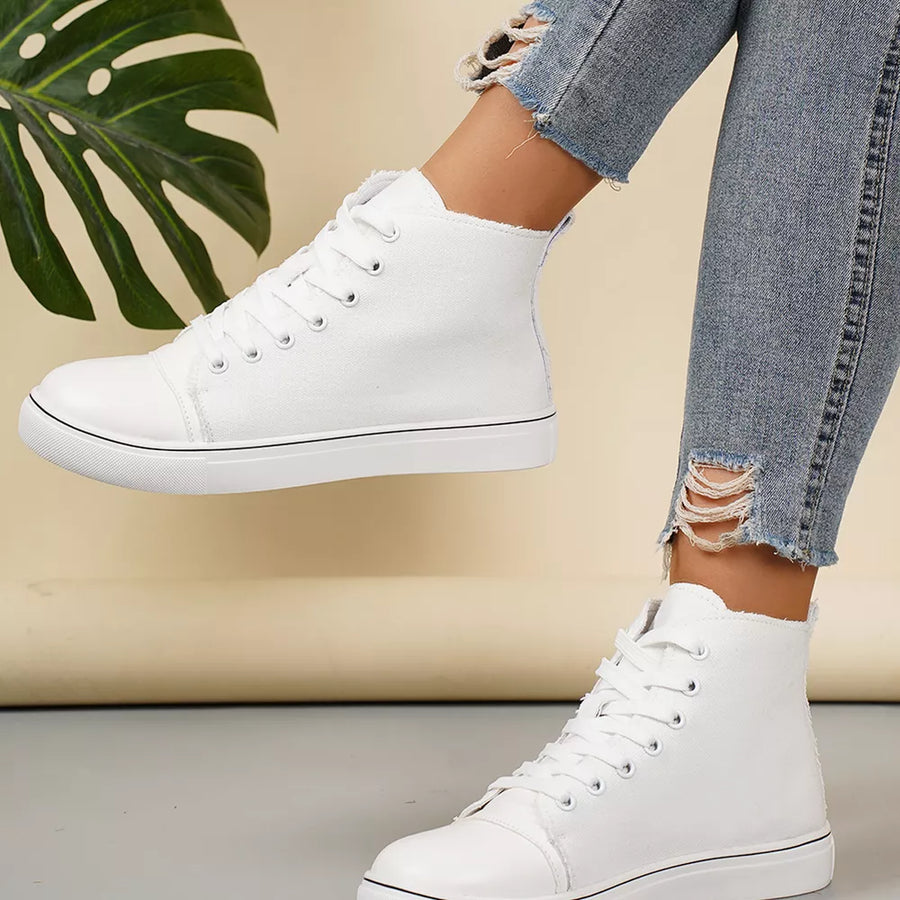White canvas lace-up high-top sneakers with black trim detail.