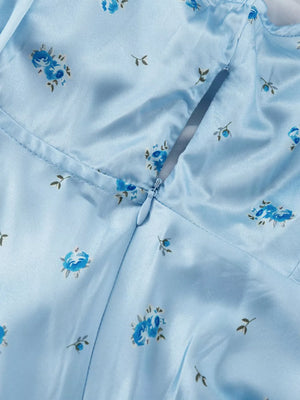 Light blue satin mini dress with a blue floral print and a back zipper closure.