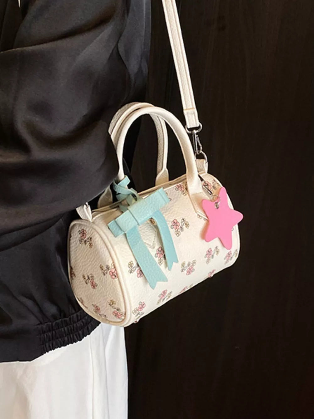 Charming floral mini crossbody bag with bow and star charm, barrel shape, adjustable strap
