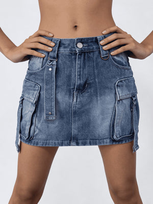 Plus size dark blue washed denim cargo skirt with button closure and utility pockets.