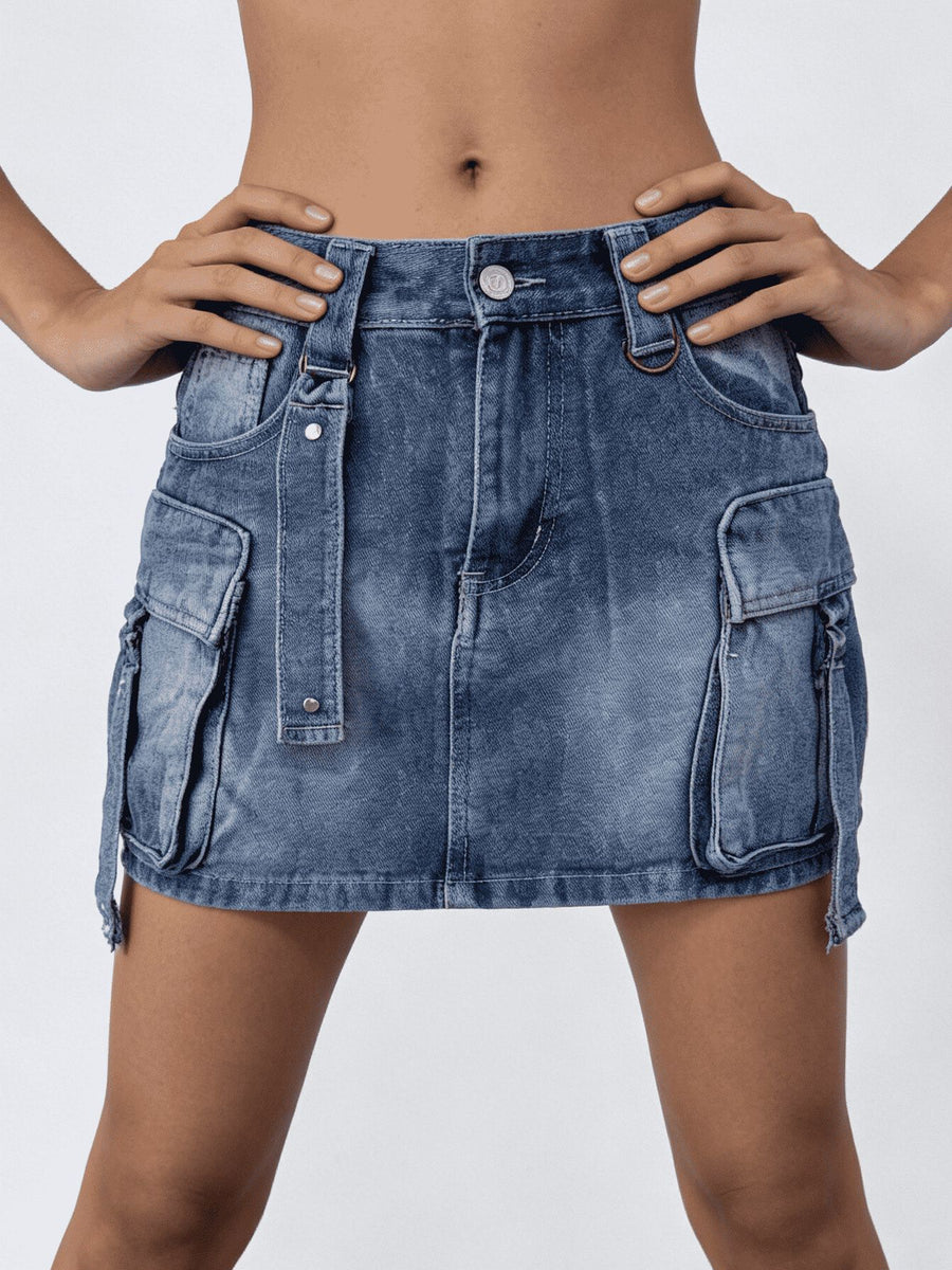 Plus size dark blue washed denim cargo skirt with button closure and utility pockets.
