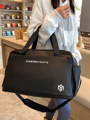 Black Oxford cloth travel duffle bag with adjustable strap and logo detail