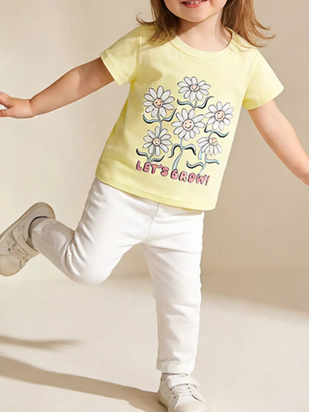 Yellow cotton t-shirt with daisy graphic and LET'S GROW text for kids