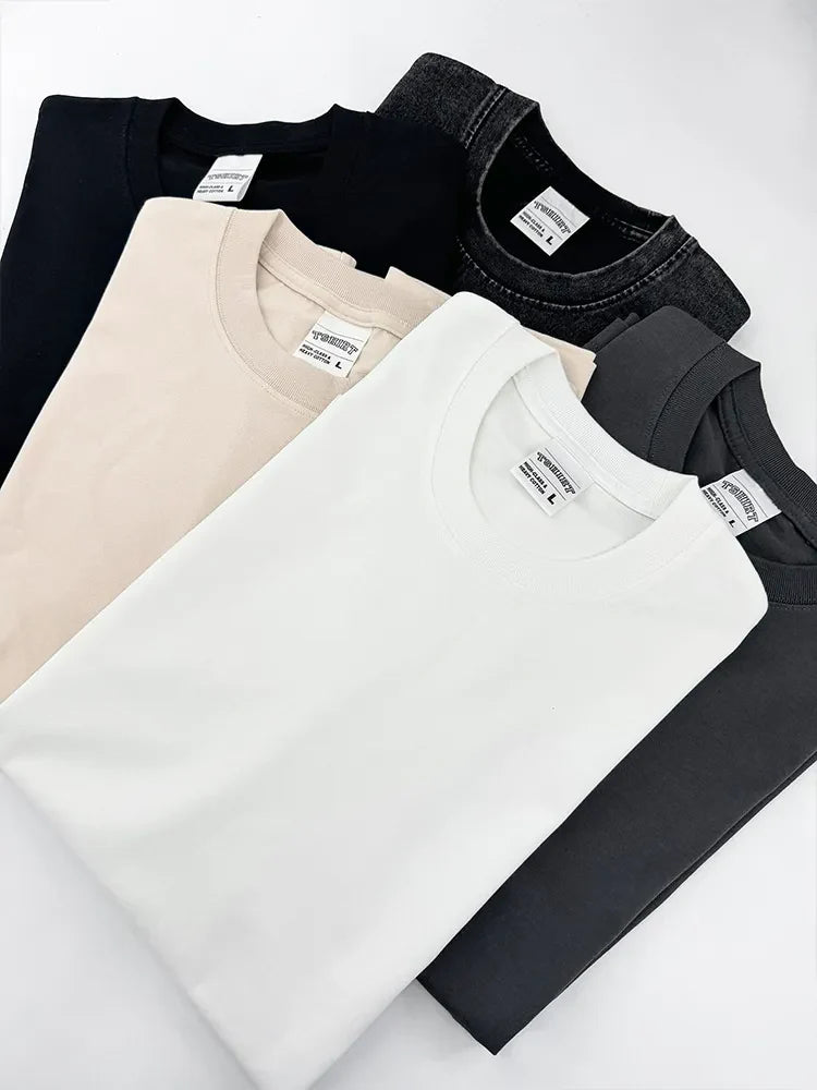 Acid wash oversized crew neck tees in black, beige, white, and gray.