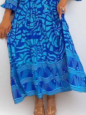 Vibrant abstract print midi dress in sky blue with button front and tiered hem.