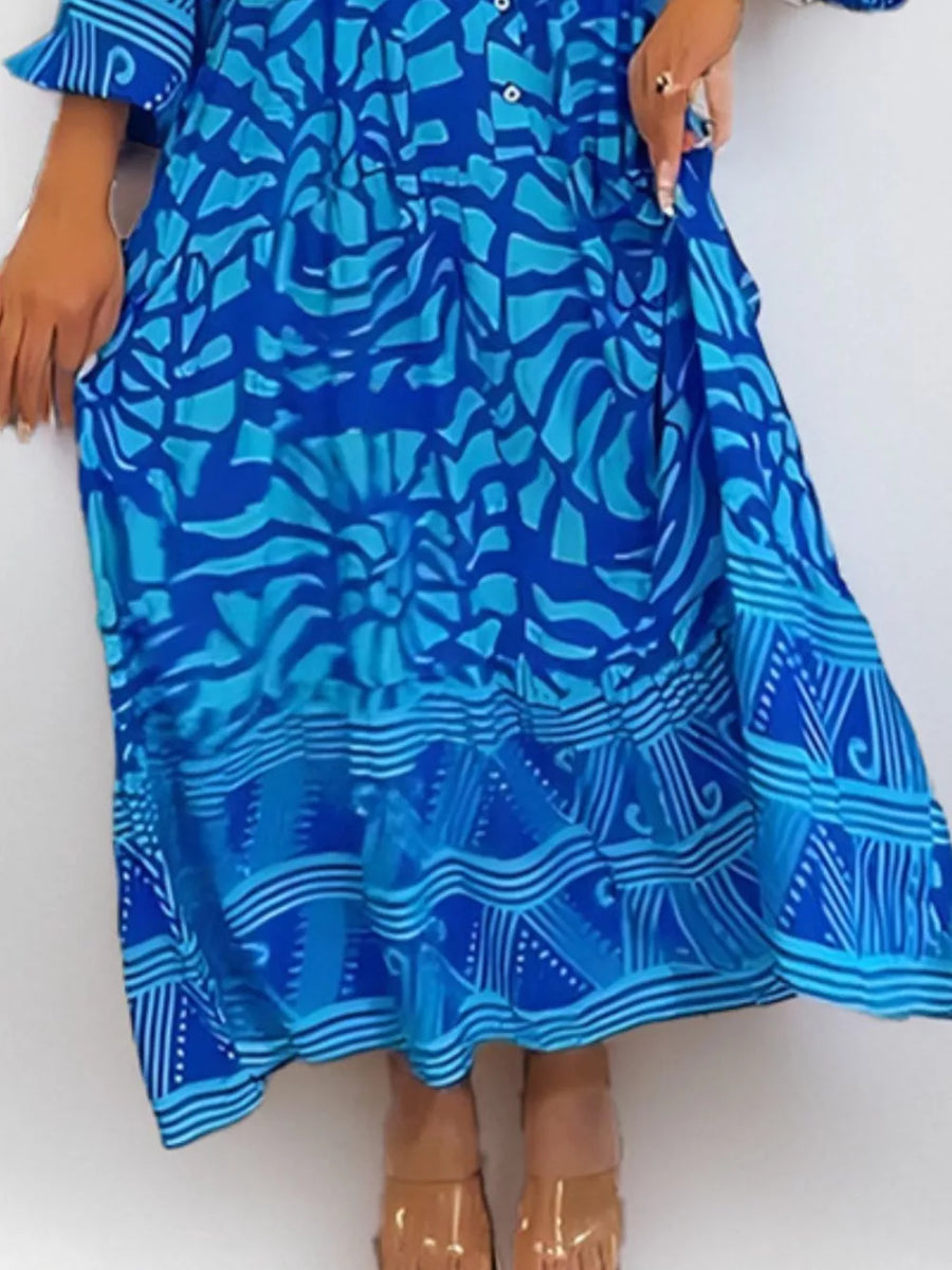 Vibrant abstract print midi dress in sky blue with button front and tiered hem.
