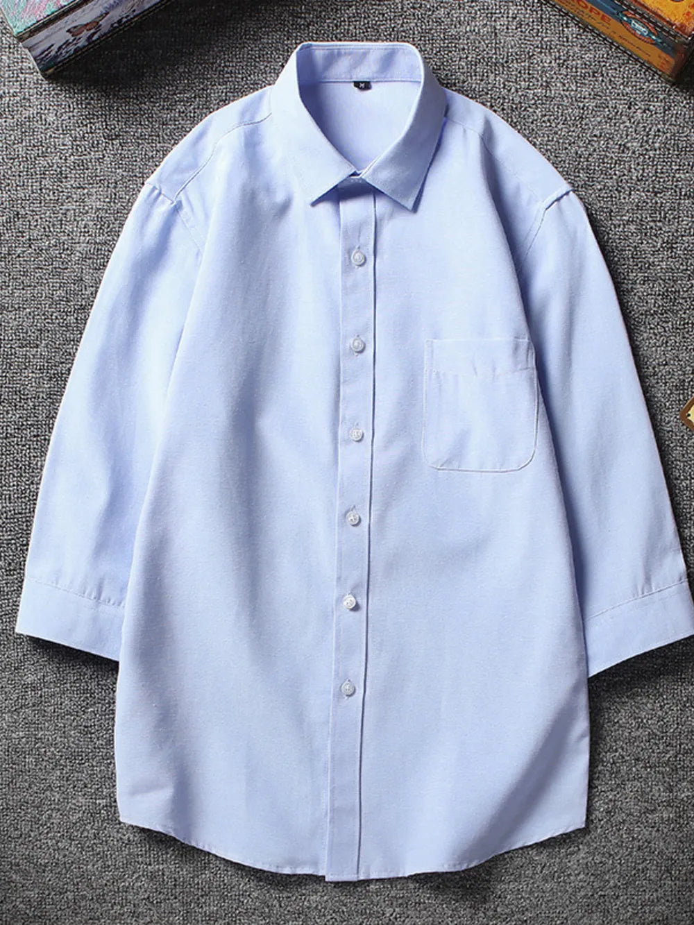 Sky blue button-up undershirt with chest pocket and 3/4 sleeves