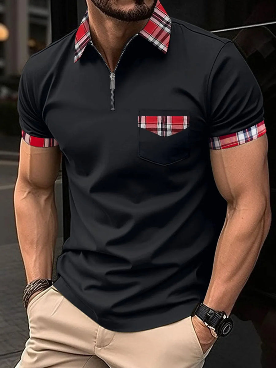 Black zip polo shirt with plaid collar, pocket and sleeve trim.