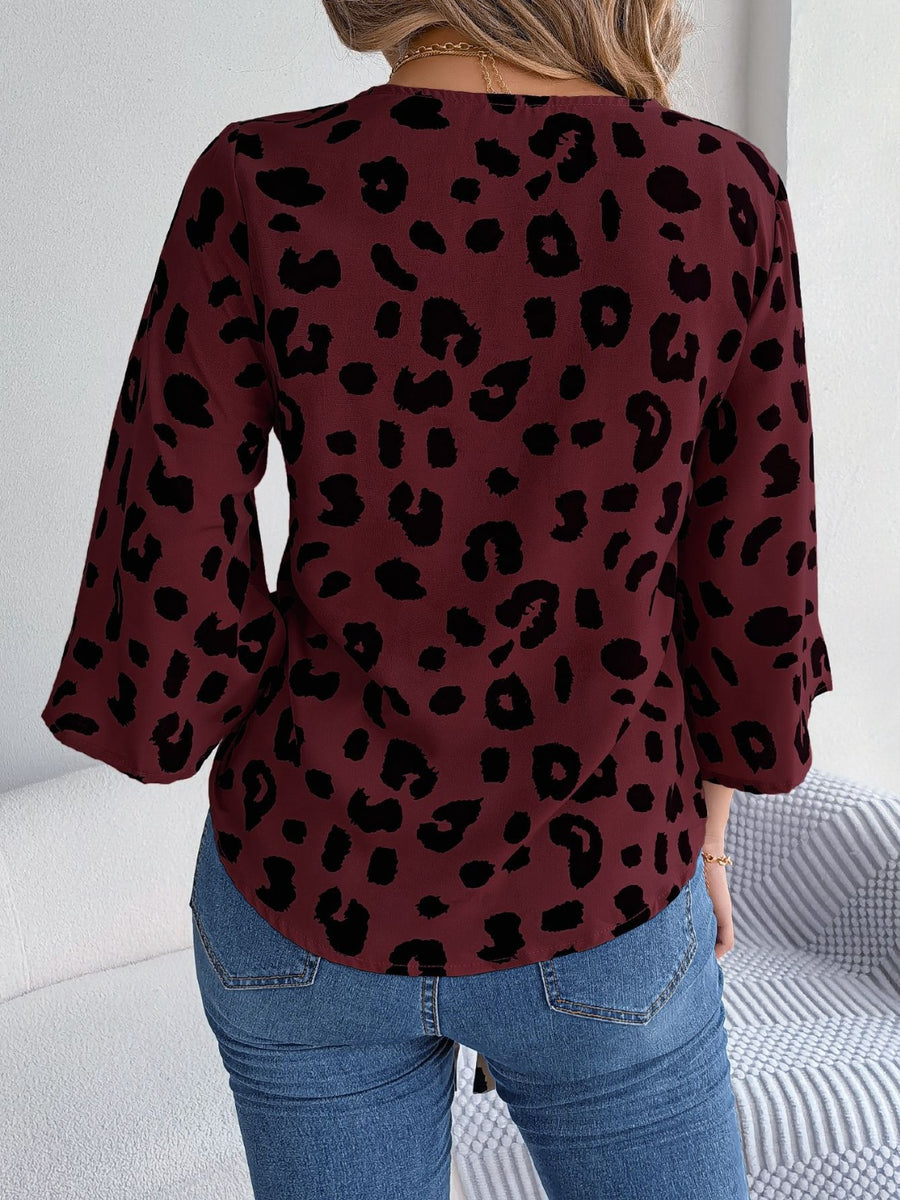 Burgundy leopard print tie-front blouse with bell sleeves.