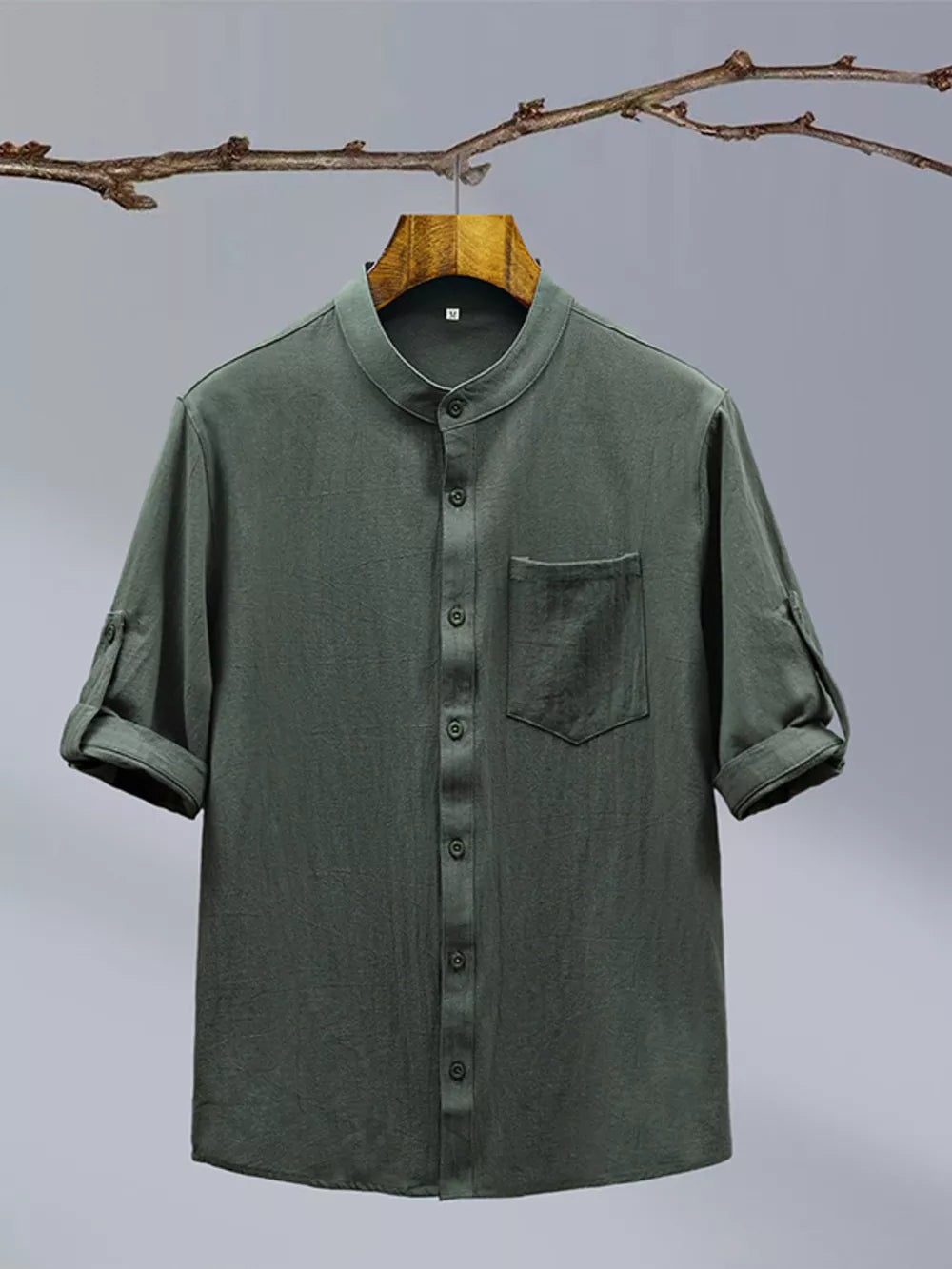 Dark green cotton blend short sleeve shirt with mandarin collar and chest pocket.