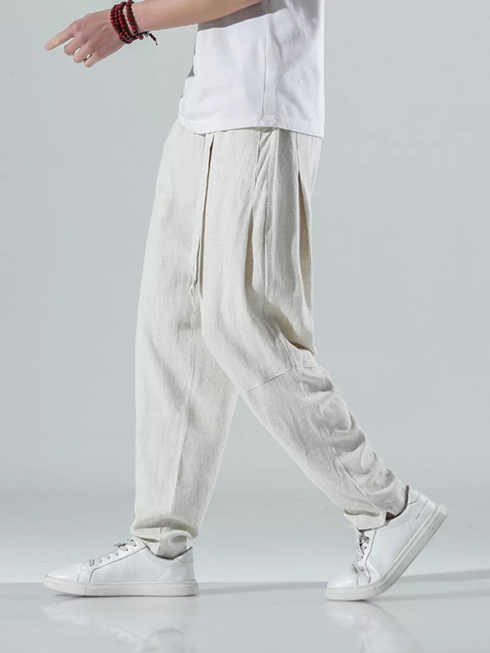 Men's beige white relaxed fit casual sweatpants with drawstring waist and pleated front.