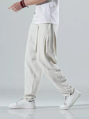 Men's beige white relaxed fit casual sweatpants with drawstring waist and pleated front.