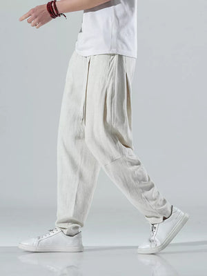 Men's beige white relaxed fit casual sweatpants with drawstring waist and pleated front.