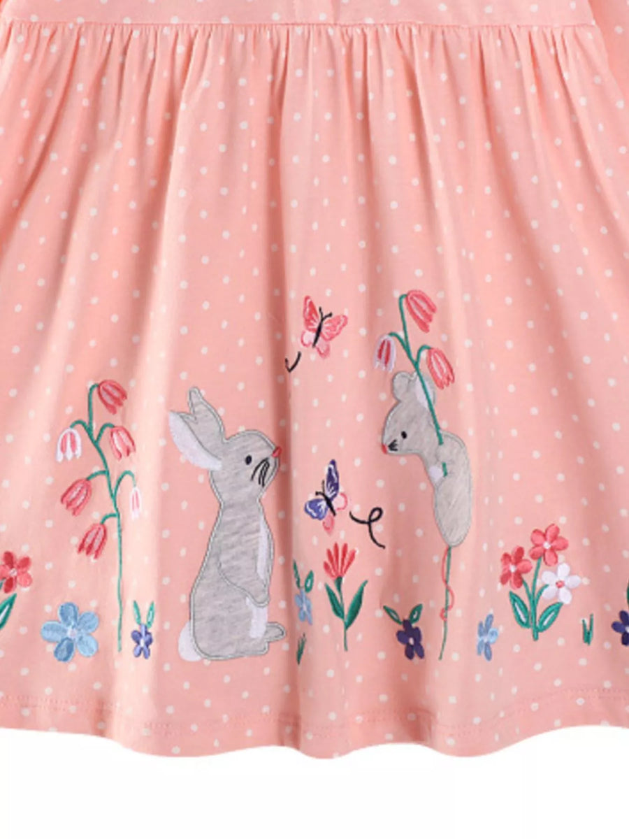 Watermelon pink polka dot cotton dress with embroidered bunnies, butterflies, and flowers.
