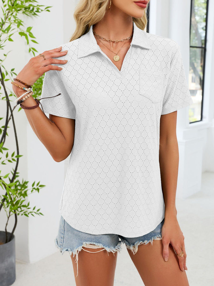 White eyelet polo collar blouse with short sleeves and a chest pocket.