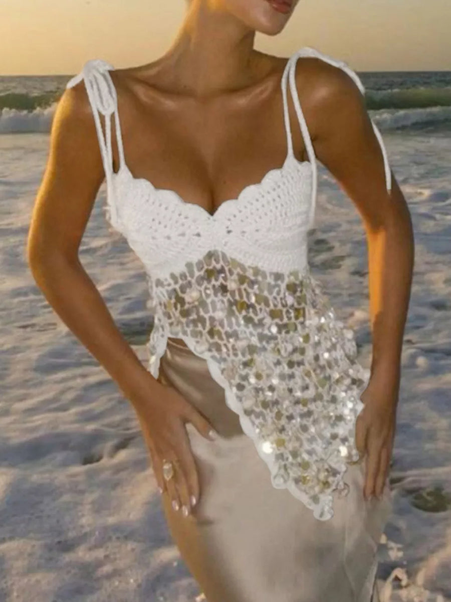 White crochet tank top with sequin detail and tie straps worn with a satin skirt.