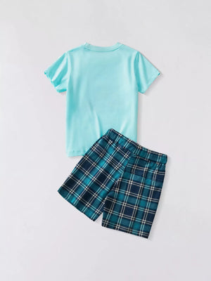 Light blue t-shirt with plaid shorts.