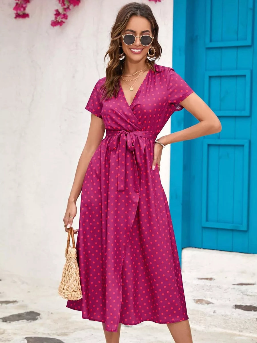 Wrap dress in magenta with red polka dots, V-neck, short sleeves, tie waist, midi length
