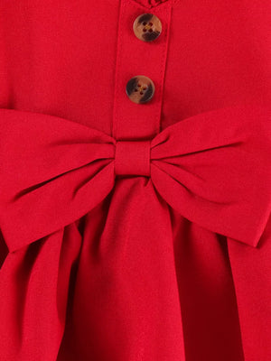 Red baby top with bow detail and button front, part of a set with denim shorts.