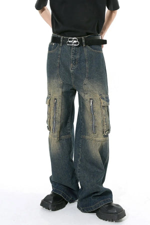 Dark distressed wide-leg cargo jeans with zippered pockets and a black belt.