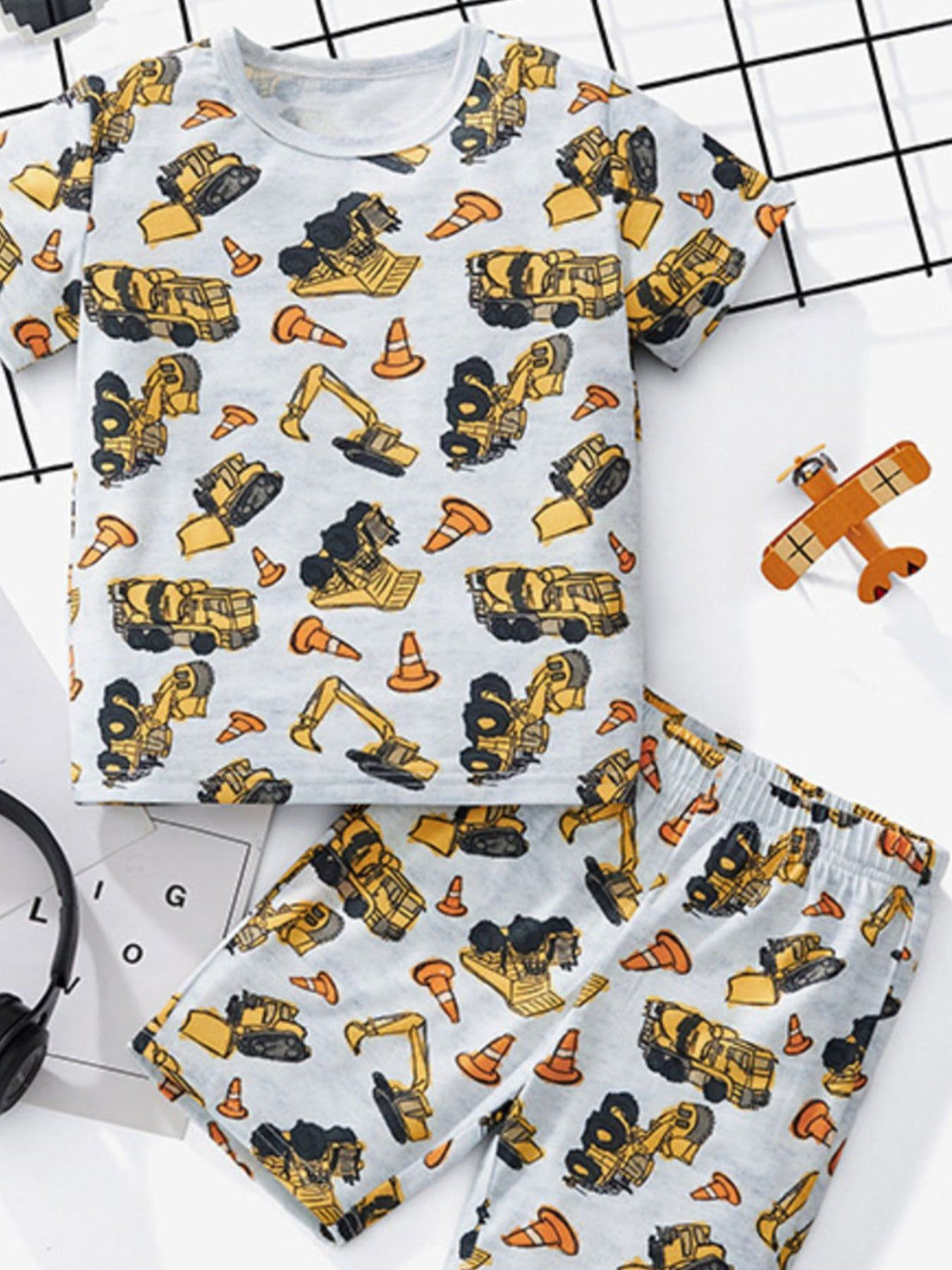 Toddler construction vehicle tee and shorts set with all-over print and crew neck.