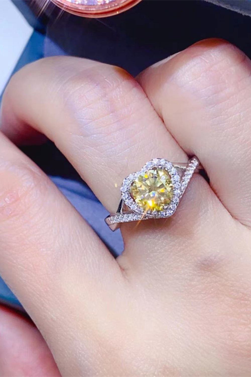 Yellow heart halo moissanite ring in silver with pave band.