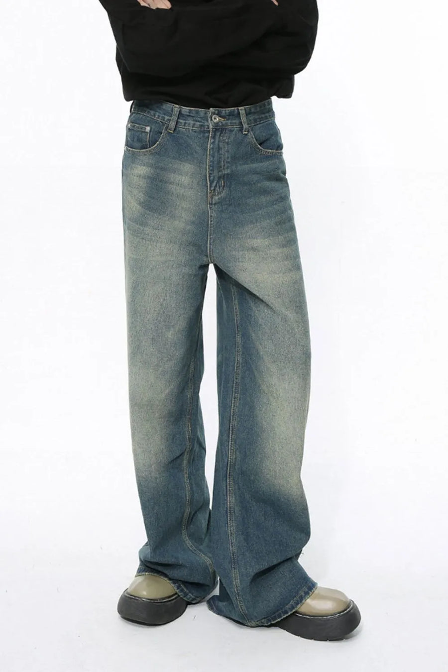 Faded wash wide-leg jeans in medium blue denim with a relaxed fit.