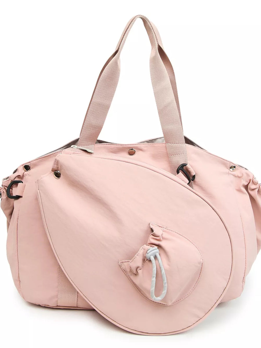 Pink athletic nylon tote bag with racket holder and cinch-cord pocket.