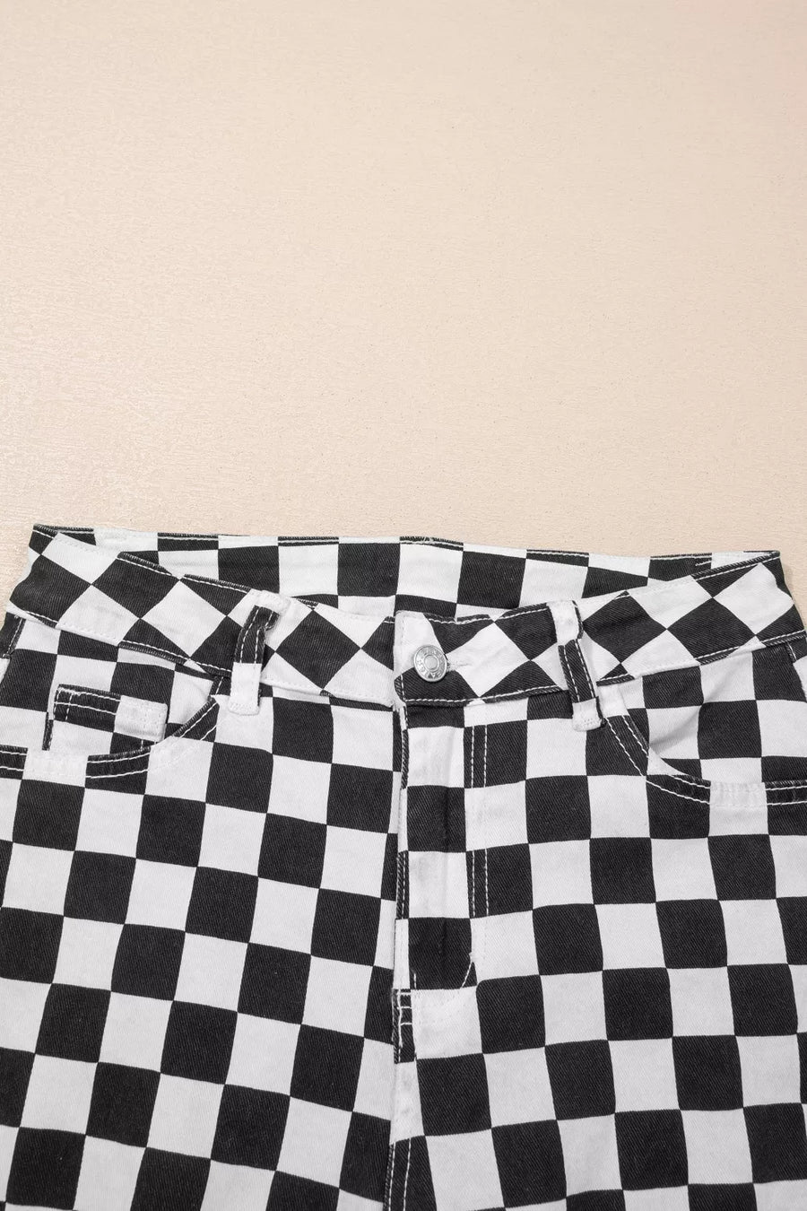 Checkerboard distressed cropped jeans in black and white denim with a button fly.