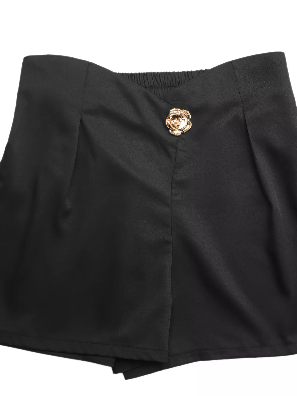 Black high-waisted pleated shorts with decorative rose button detail.