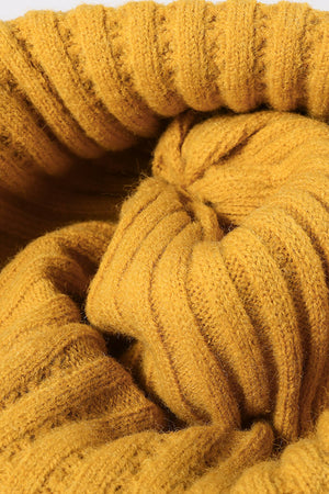 Textured ribbed knit beanie in mustard acrylic with a casual style.
