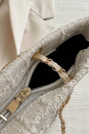 White bouclé shoulder bag with gold chain and leather strap detail