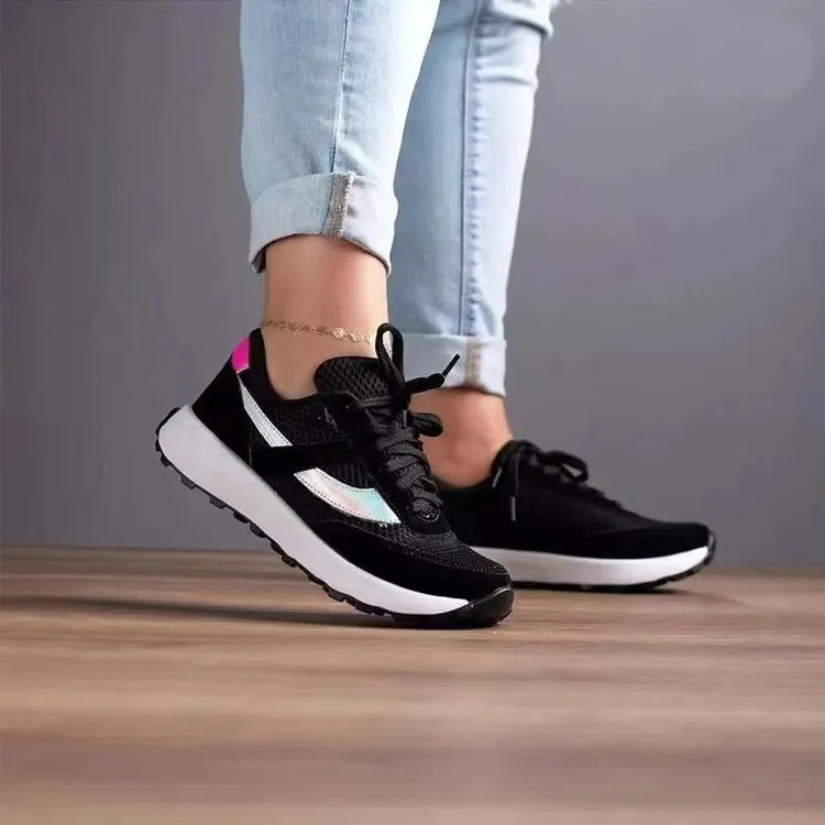 Black mesh runners with iridescent panels and pink heel detail