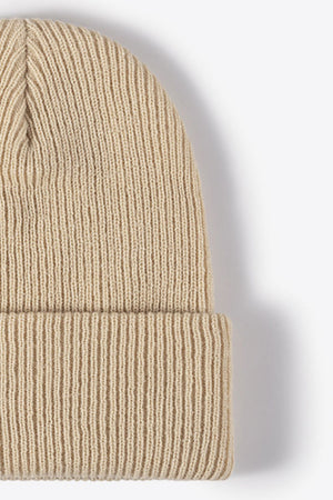 Beige ribbed knit beanie with a cuffed hem