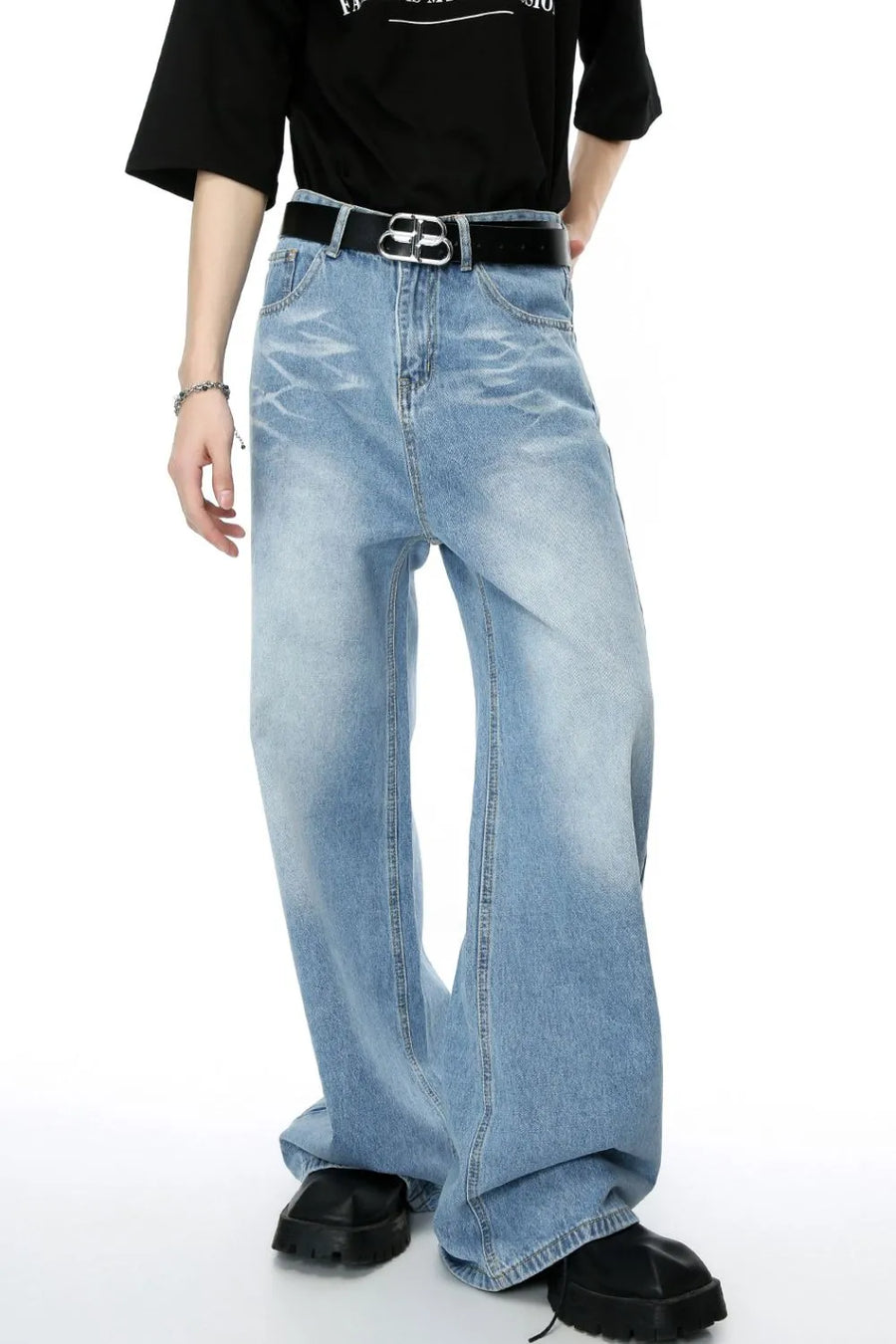 Oversized denim palazzo jeans in medium wash with subtle fading and a wide leg.