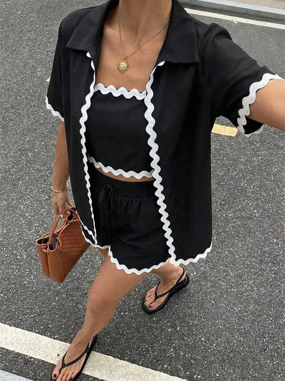 Black cami shorts set with scalloped trim, collared short sleeve shirt, and drawstring shorts.