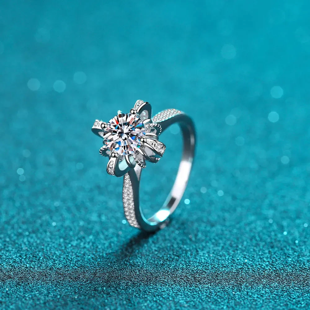 Sterling silver ring with a sparkling floral-shaped center stone and pave band.