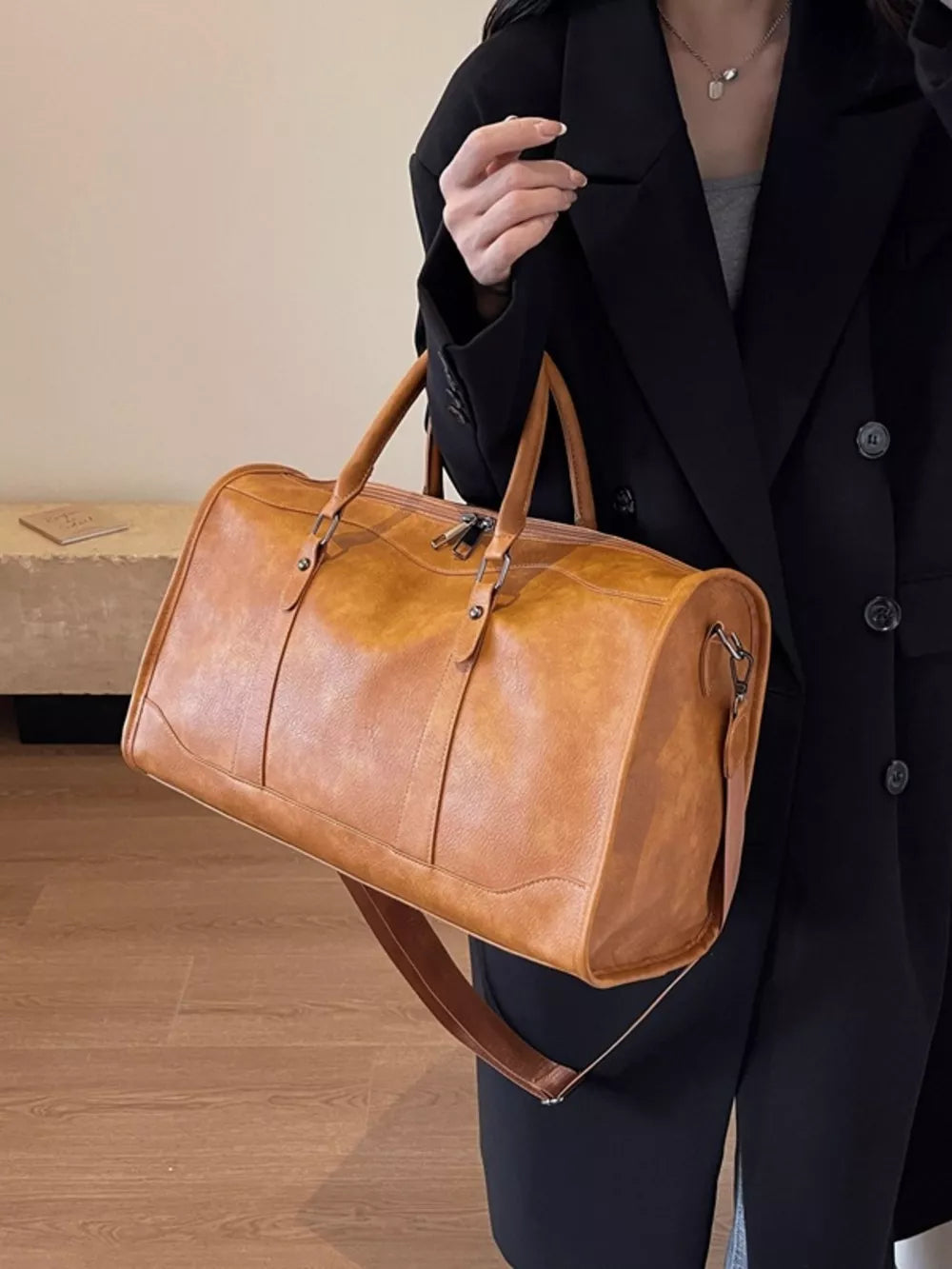 Cognac vintage leather duffle bag with top handles and shoulder strap