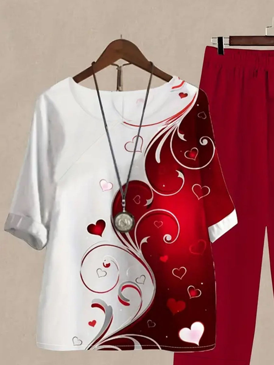 White and red floral print half sleeve top with matching red pants set.